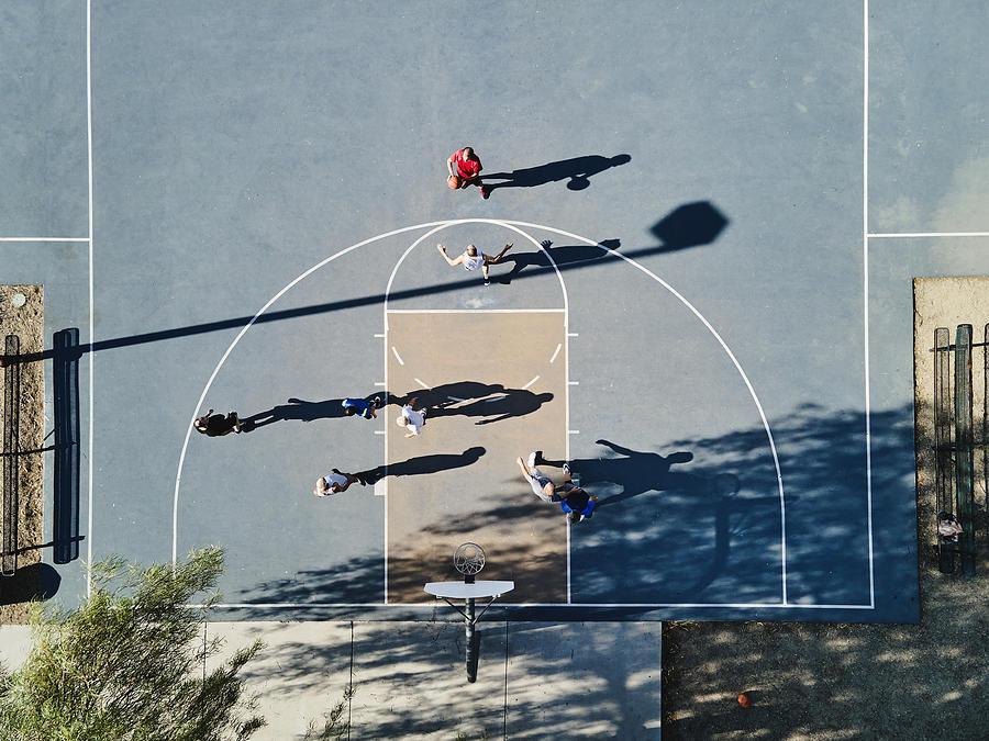 Wide shot overhead view of senior men playing basketball game on summer morning Photograph by Thomas Barwick