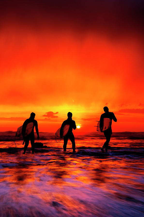 Widemouth Bay,  Surfers at sunset, Cornwall, England Photograph by Maggie Mccall