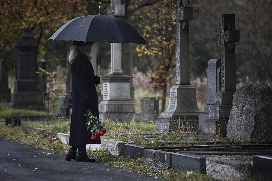 Widow Bringing Roses To A Grave In A Cemetery Photograph by Andrew Bret Wallis