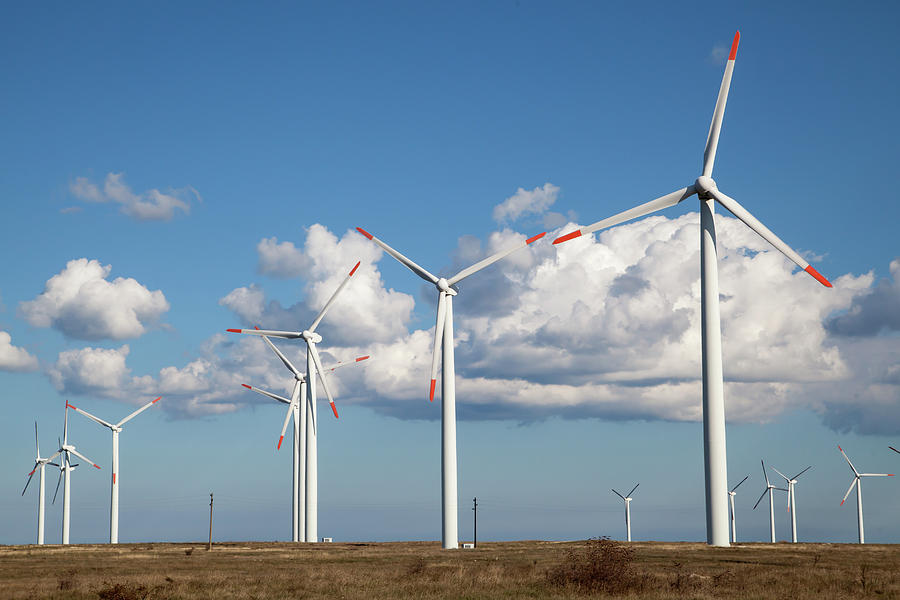 Agriculture Photograph - Wind turbine farm over the blue clouded sky by Michael Dechev Agriculture Photograph - Wind turbine farm over the blue clouded sky by Michael Dechev