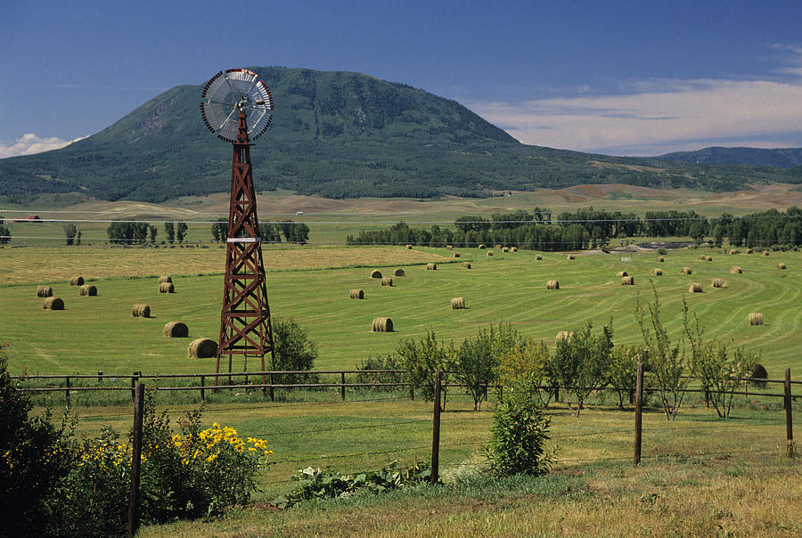 Windmill and haystacks on farm, Steamboat  Springs, Colorado, USA Photograph by Karl Weatherly