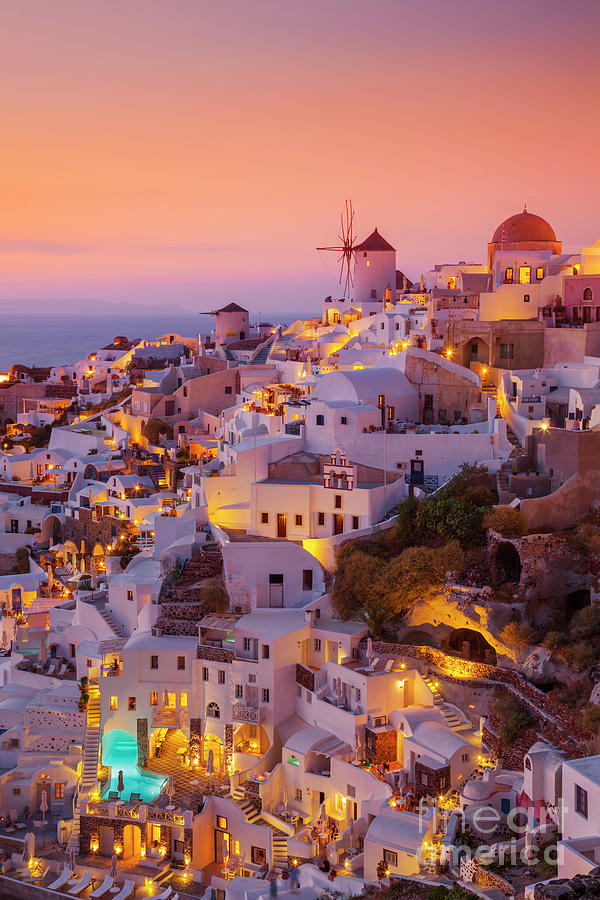 Windmill and white houses at sunset, Oia, Santorini, Greece Photograph by Neale And Judith Clark