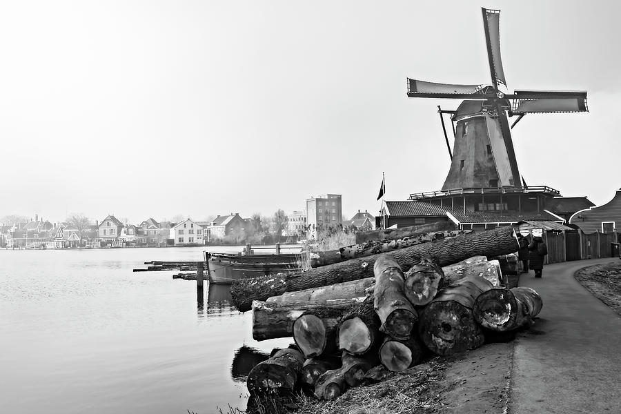 Windmill in calm waters Photograph by Pedro Cardona Llambias