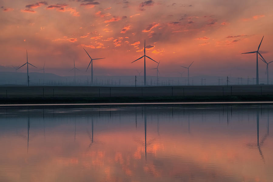 Windmill turbines at sunrise with reflection Photograph by Mikhail Kokhanchikov