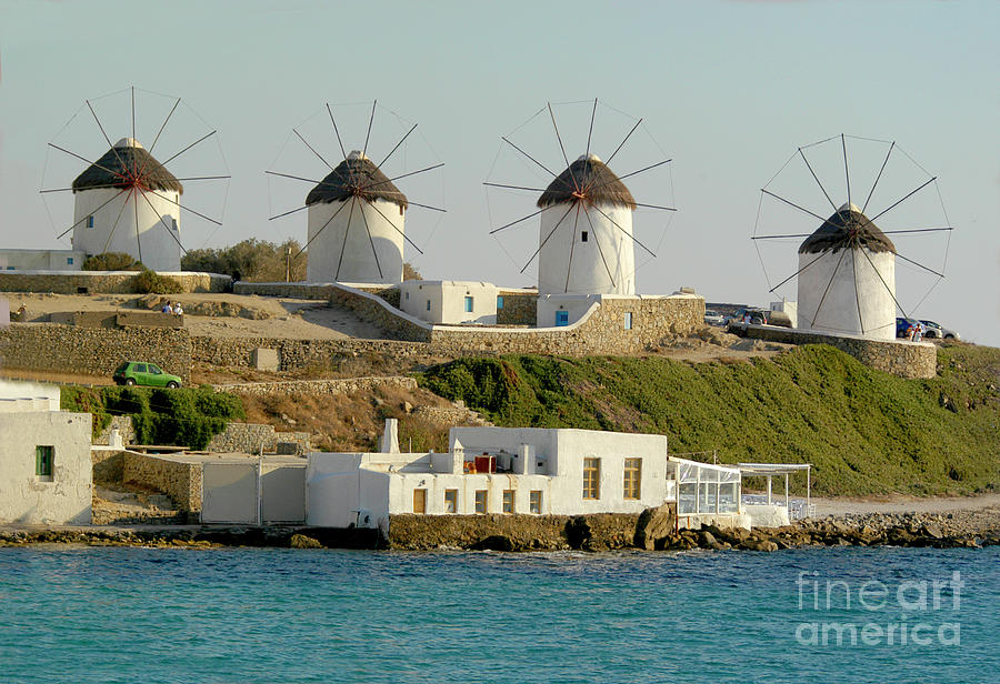 Windmills lined up in a row on the island of Mykonos, Greece. Photograph by Gunther Allen
