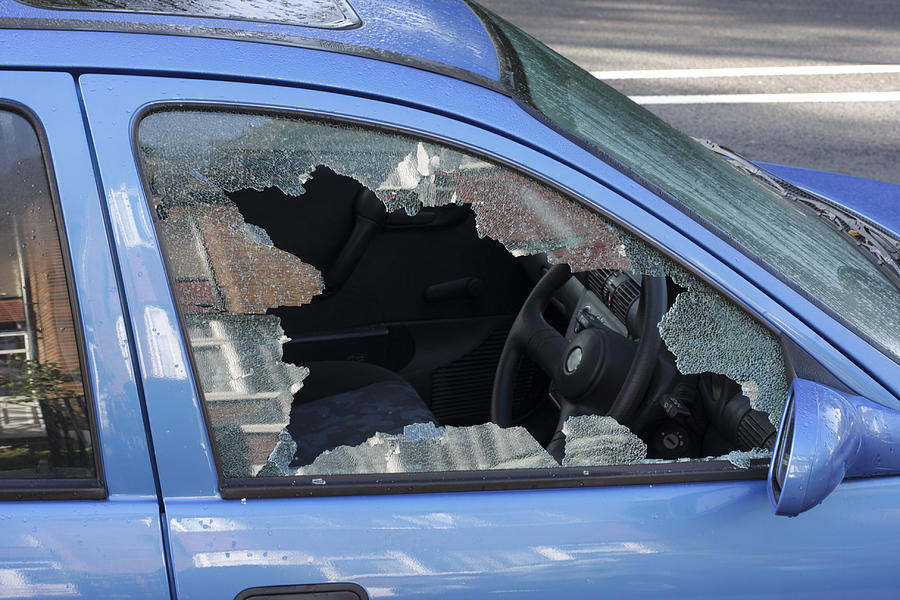 Window smashed by car thief street scene Photograph by Whiteway