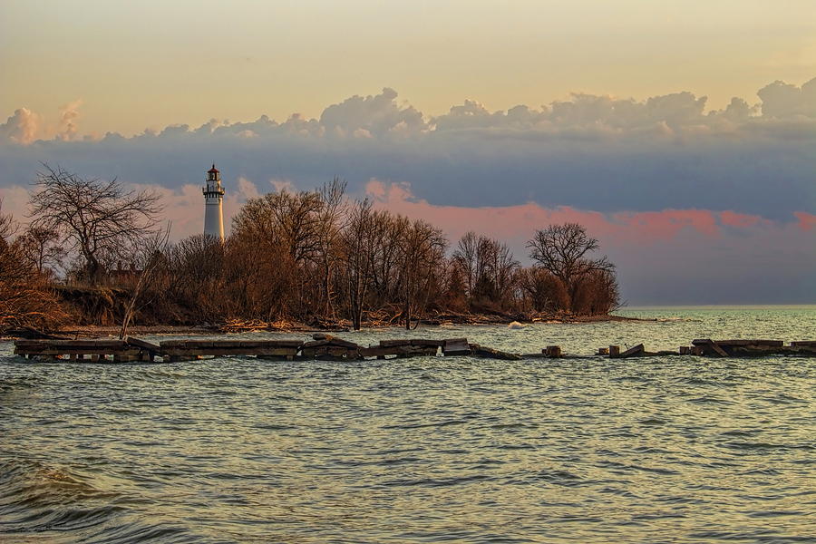 Windpoint Lighthouse On The Horizon Photograph by Dale Kauzlaric