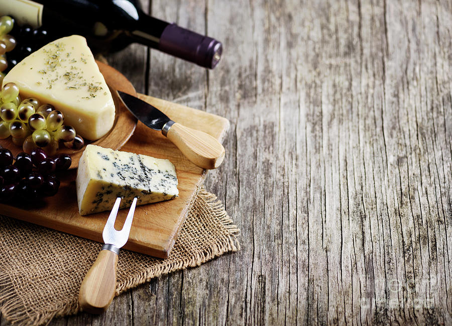 Wine and Cheese wuth grapes on wooden table Photograph by Jelena Jovanovic