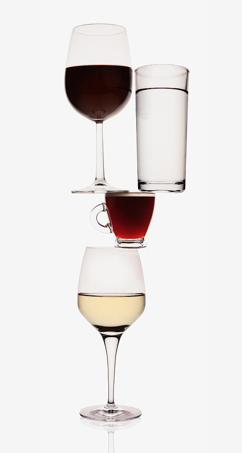 Wine, water and espresso glasses balancing Photograph by Caiaimage/Anthony Lee