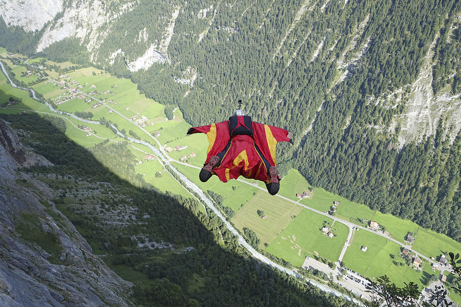 Wingsuit flier in airborne descent towards valley Photograph by Ascent Xmedia
