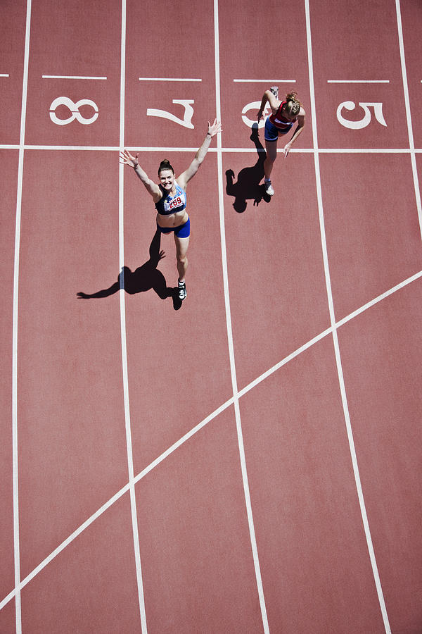 Winning runner cheering on track Photograph by Paul Bradbury