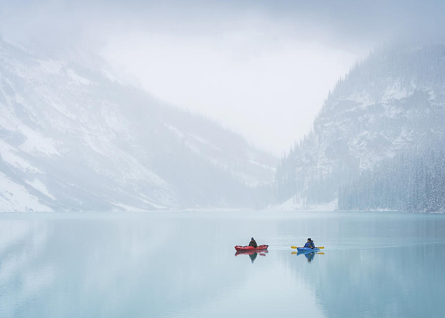 Winter kayaking on almost frozen Lake Louise in Banff National Park, Canada Photograph by Peter Kolejak