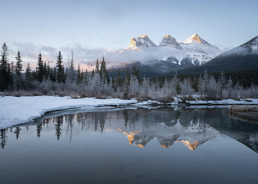 Winter sunrise scenery from Canadian Rockies with mountain reflected in water Photograph by Peter Kolejak