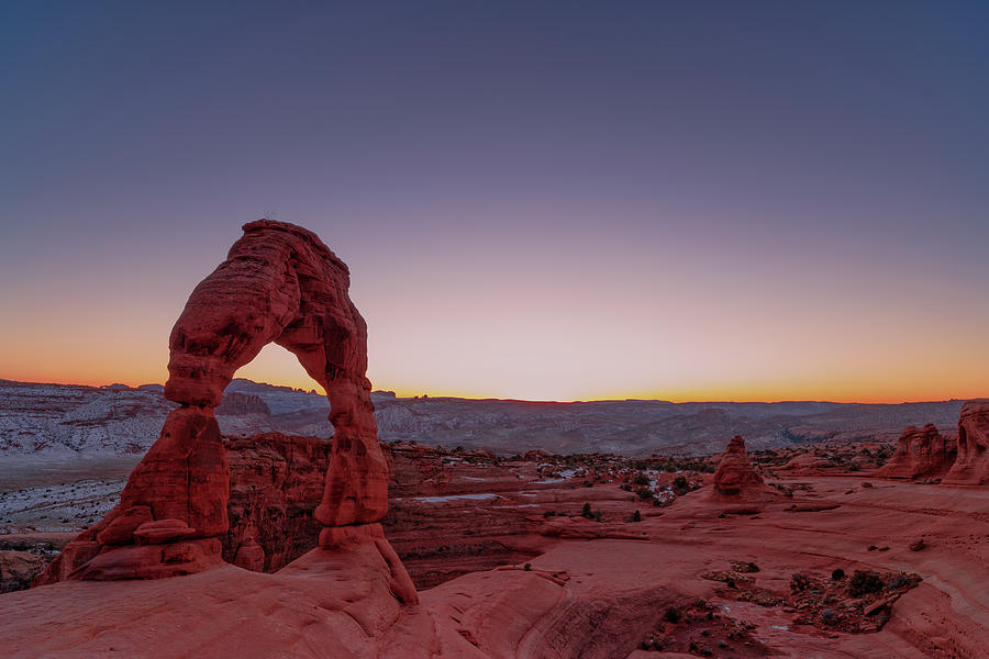 Winter sunset at Delicate Arch Photograph by Murray Rudd