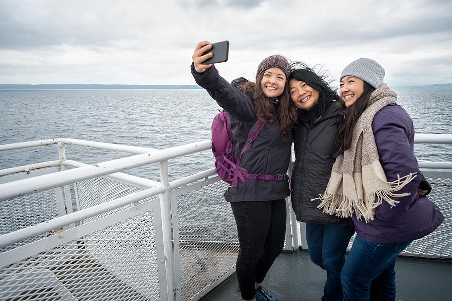 Winter Travel on Ferry, Mother and Teen Daughters Taking Selfie Photograph by PamelaJoeMcFarlane