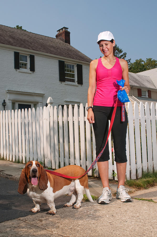 Woman and her Bassett Hound Photograph by PM Images