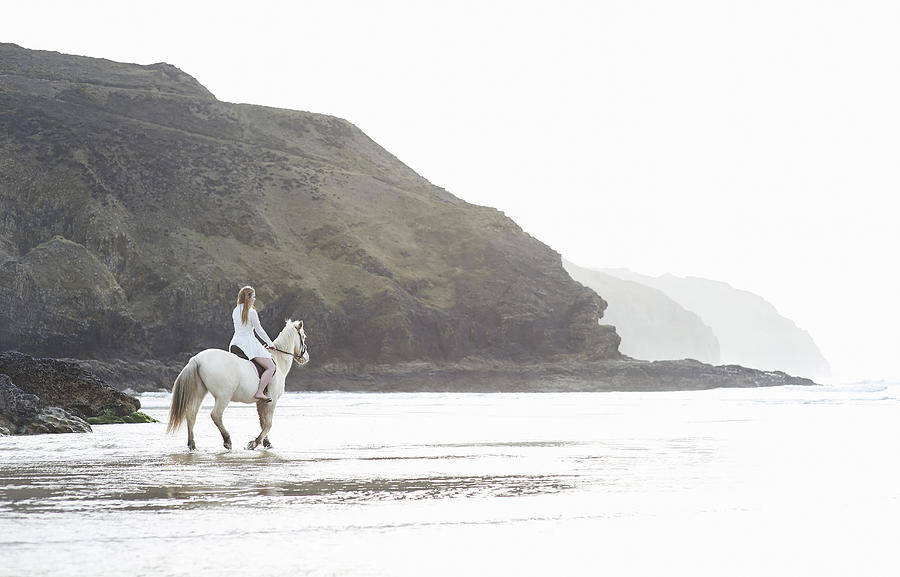 Woman and white horse on Atlantic coast Photograph by Dougal Waters