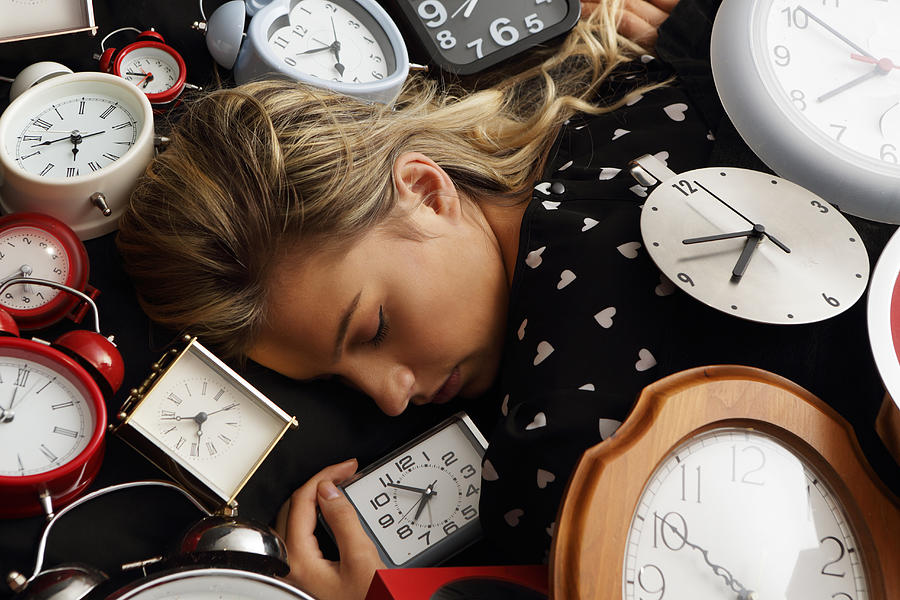 Woman Asleep Surrounded By Clocks Photograph by Peter Cade