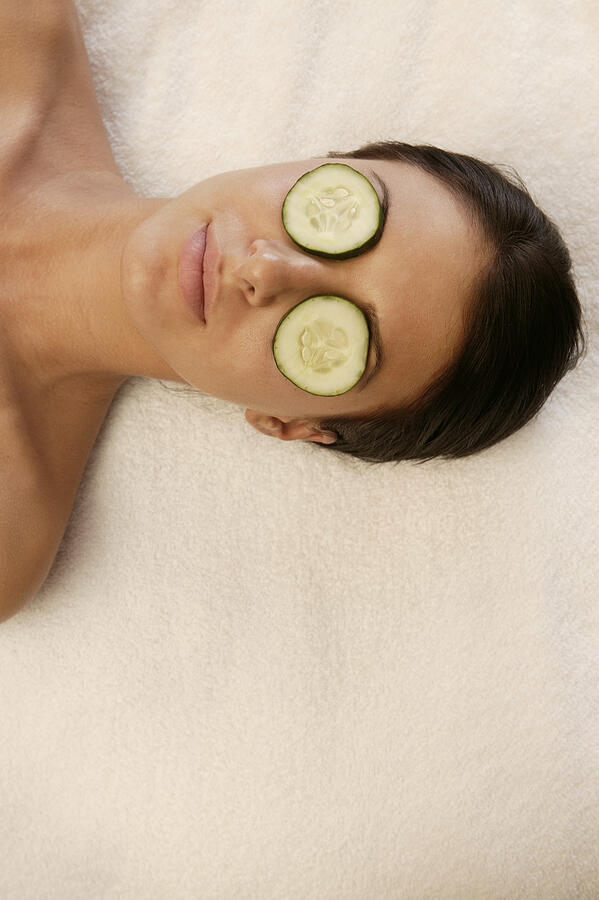 Woman at spa with cucumber slices covering eyes Photograph by Comstock Images