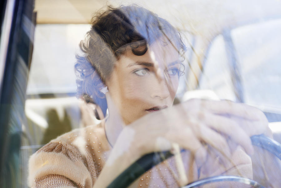 Woman At Steering Wheel In Car Photograph by Tara Moore