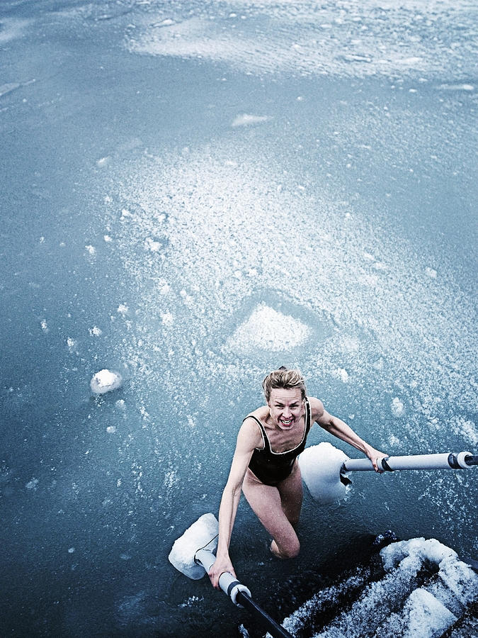 Woman bathing in icy sea. Photograph by David Trood