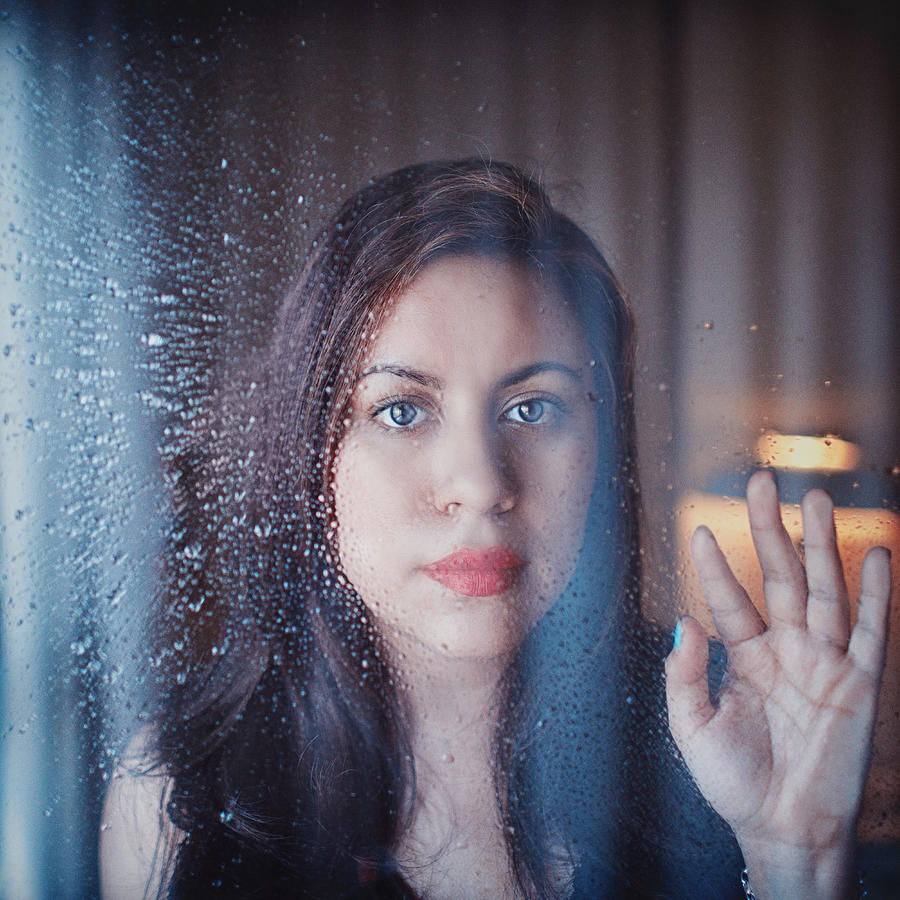 Woman behind rainy window Photograph by Julia Davila-Lampe