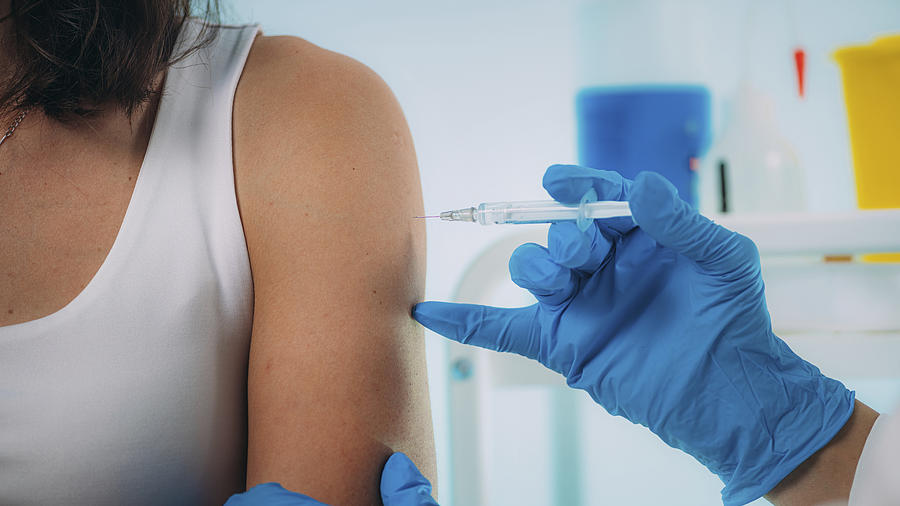 Woman being vaccinated Photograph by Microgen Images/science Photo Library