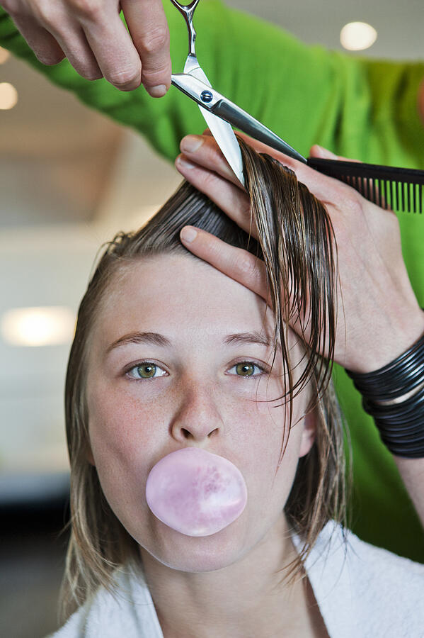 Woman blowing bubble whilst having her hair cut Photograph by Dimitri Otis