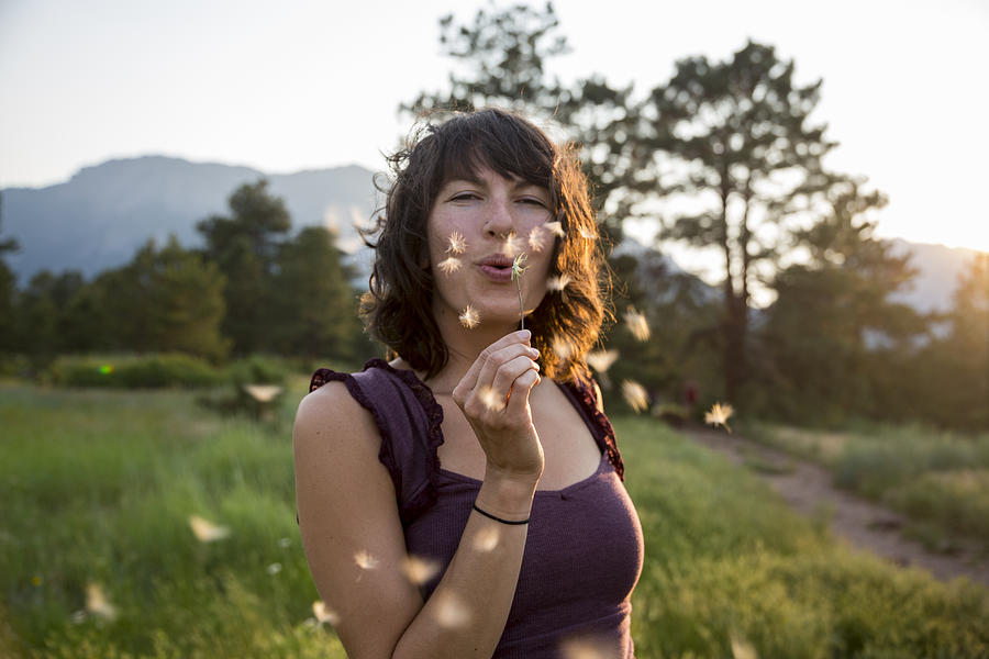 Woman blowing dandelion flower Photograph by Tegra Stone Nuess