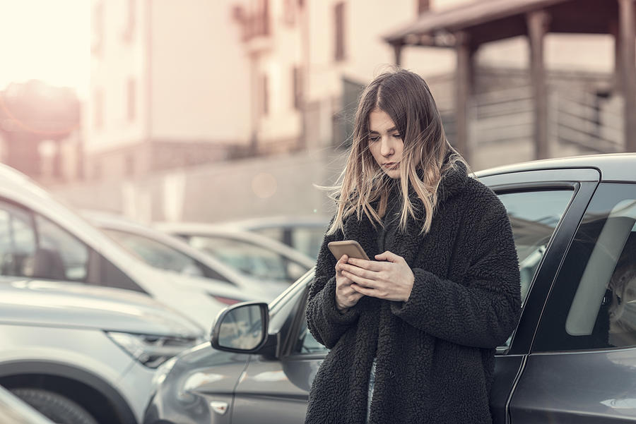 Woman checking cell phone Photograph by Francesco Carta fotografo