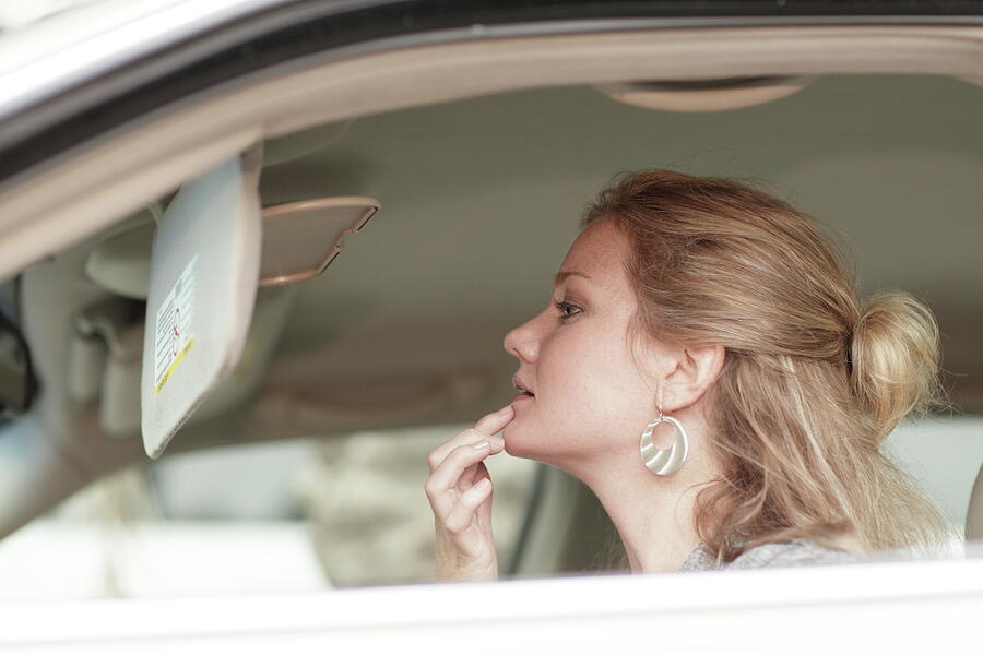 Car Photograph - Woman checking her makeup in the mirror by Felix Mizioznikov