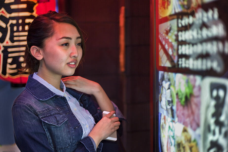 Woman checks restaurant sign Photograph by Gary Conner