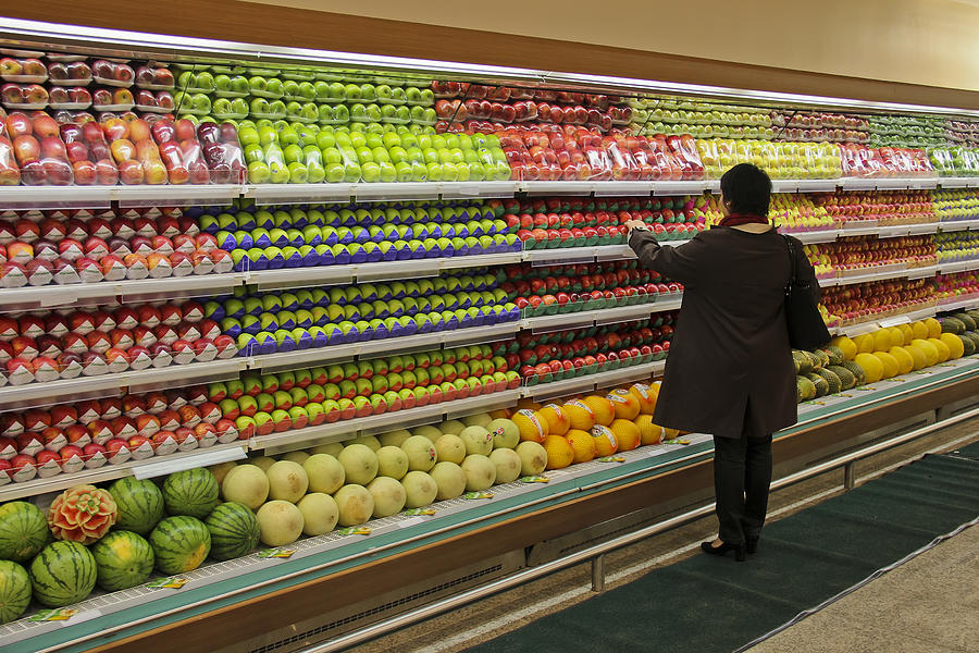 Woman choosing fresh fruits Photograph by Ruy Barbosa Pinto