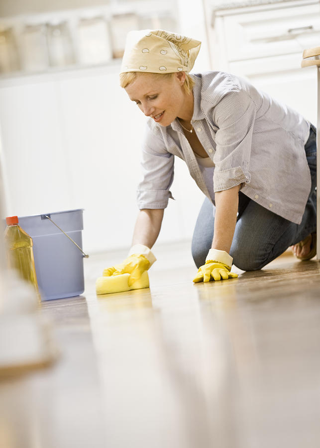 Woman cleaning Kitchen Floor Photograph by Andersen Ross