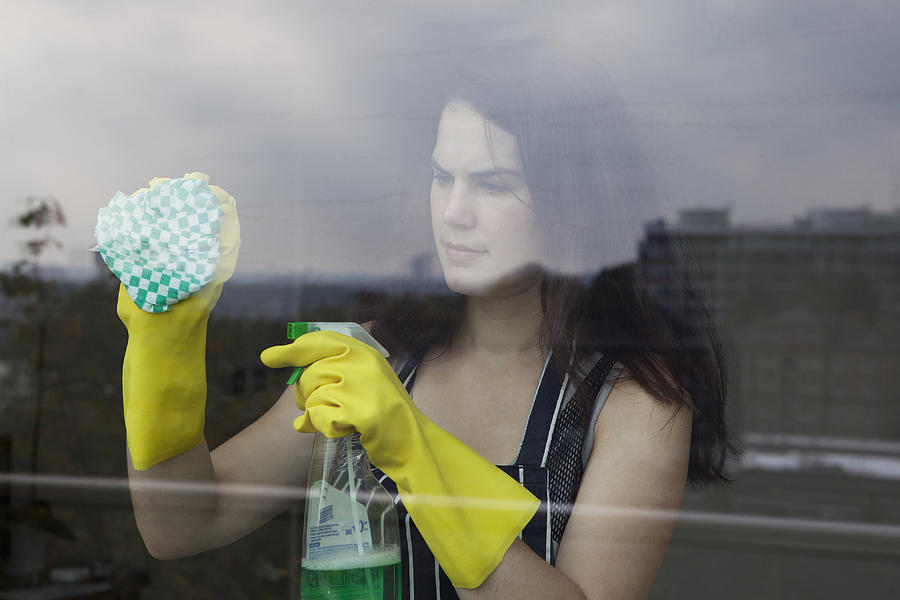 Woman cleaning window Photograph by Clarissa Leahy
