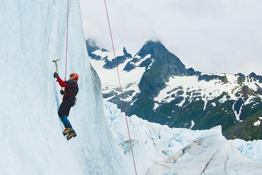 Woman climbs glacial cliff Photograph by Turner Forte