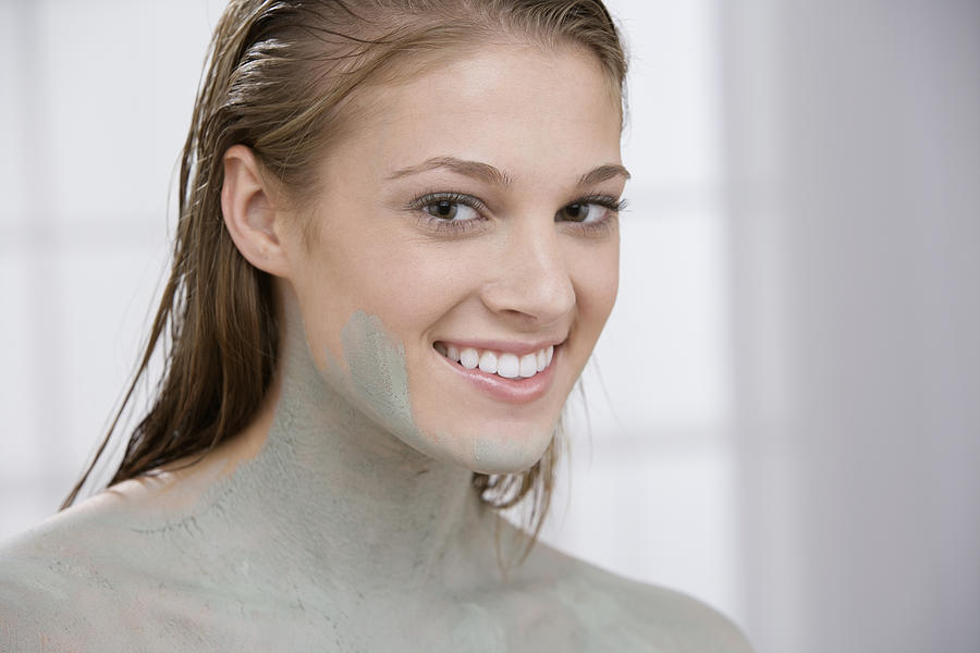 Woman covered in mud treatment Photograph by Comstock Images