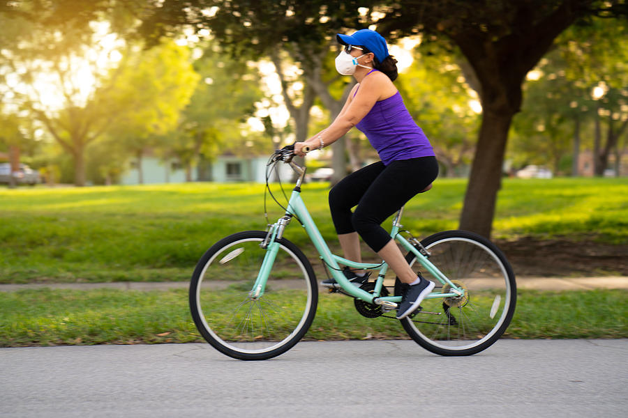 Woman cycling on the neighborhood Photograph by Thepalmer