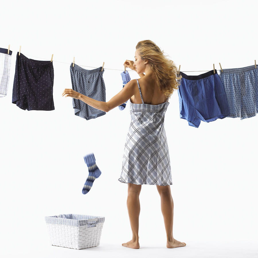 Woman doing laundry Photograph by Brand X Pictures