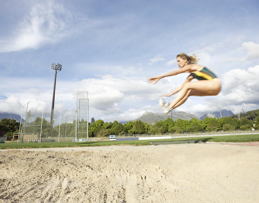 Woman Doing the Long Jump Photograph by John Cumming