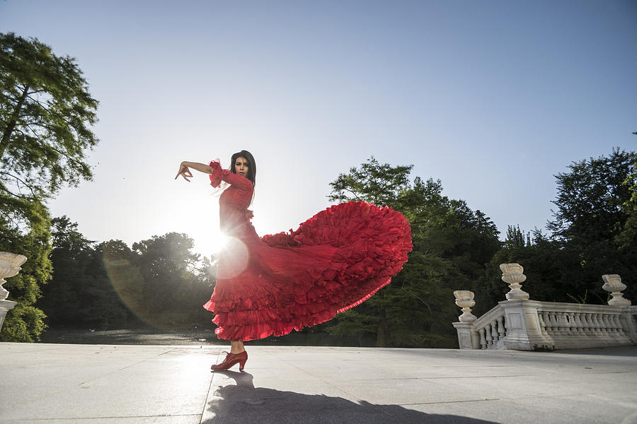 Woman dressed in red dancing flamenco on terrace at backlight Photograph by Westend61