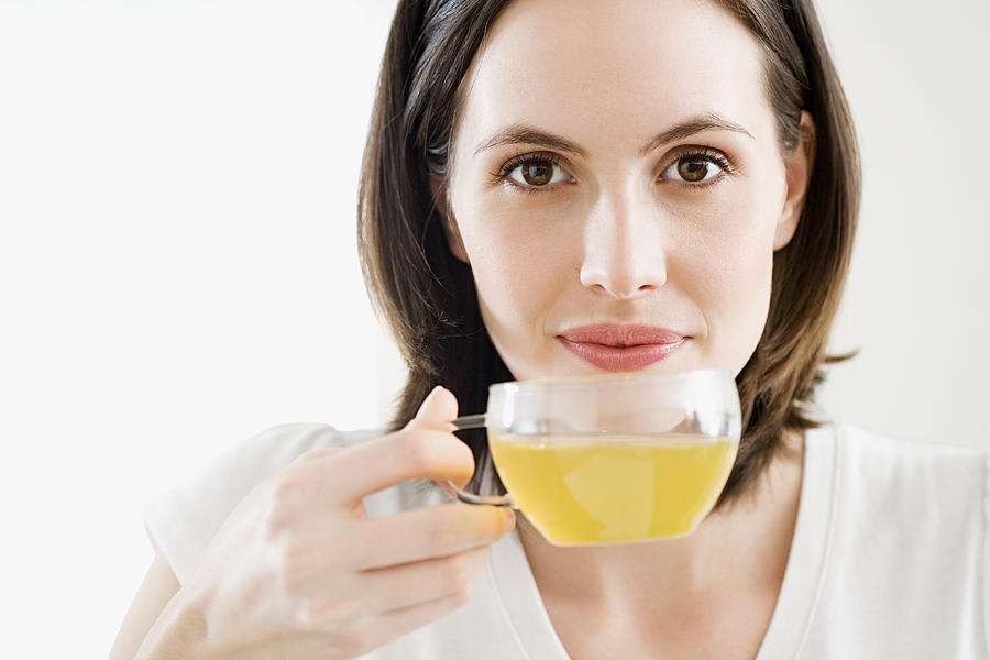 Woman drinking green tea Photograph by Image Source