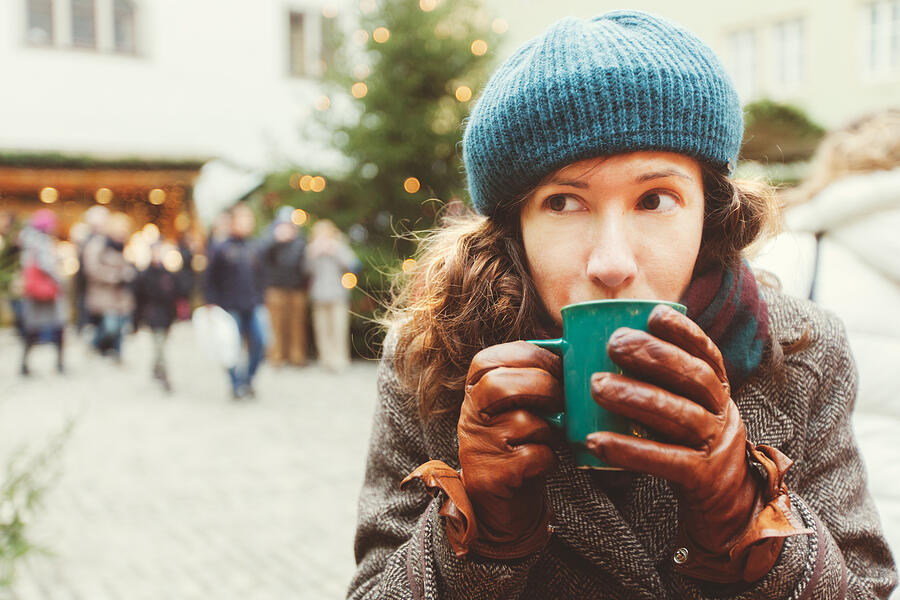 Woman drinking hot wine at the Christmas market Photograph by Photo by Rafa Elias