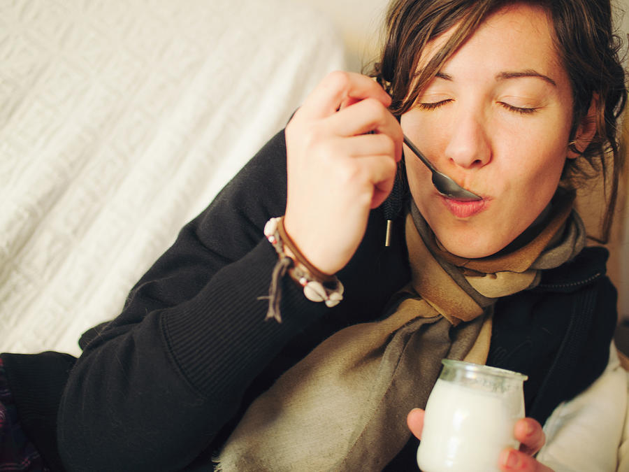 Woman eating yogurt Photograph by Rafael Elias