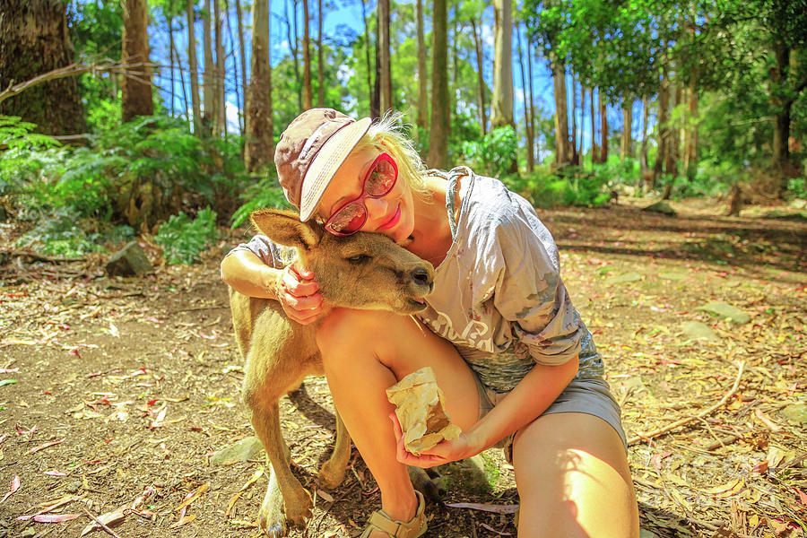 Woman embraces kangaroo Photograph by Benny Marty