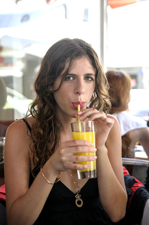 Woman enjoying a drink of  fresh juice Photograph by PhotoStock-Israel