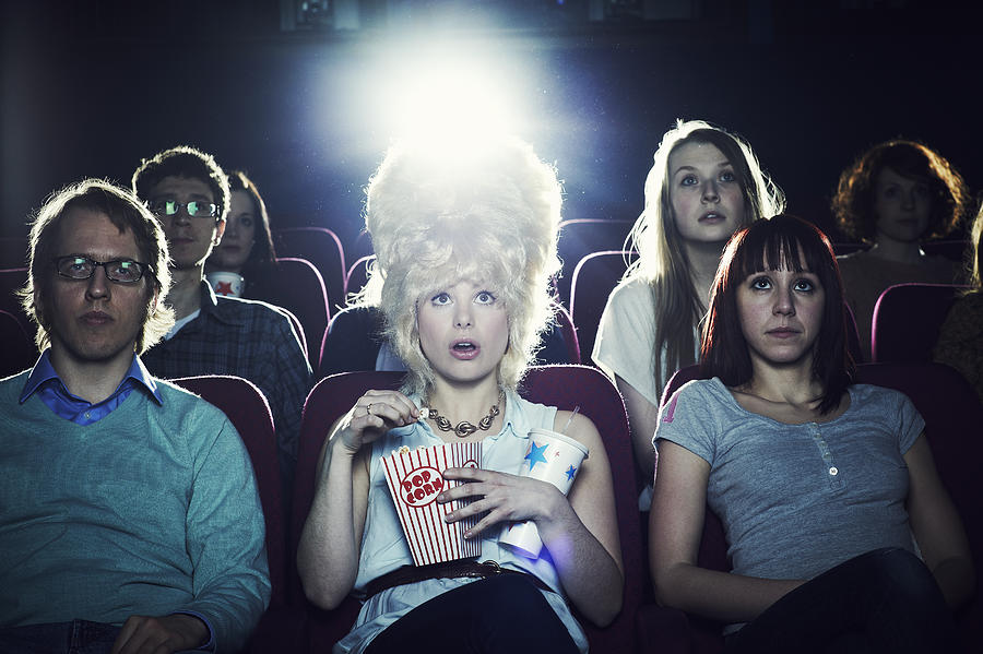 Woman enjoying movie at cinema Photograph by Flashpop