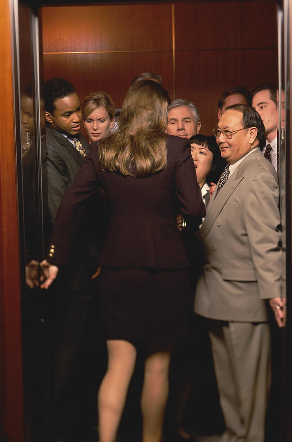 Woman Entering Crowded Elevator Photograph by Keith Brofsky
