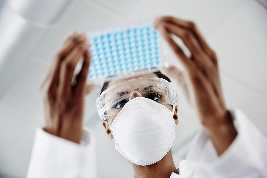 Woman examining laboratory samples Photograph by Thomas Tolstrup