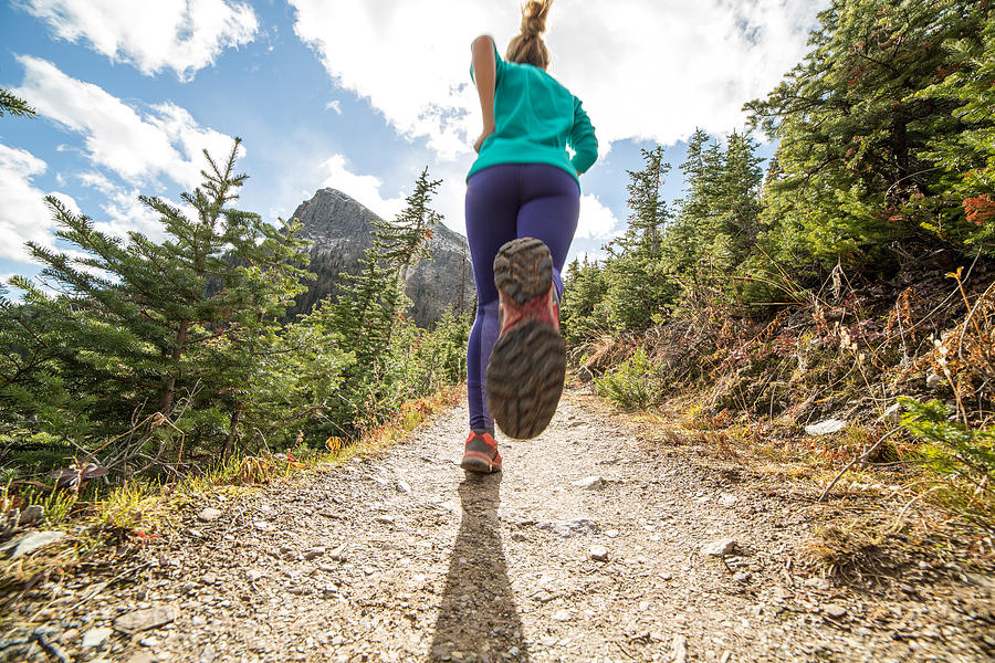 Woman exercising for cross-country running Photograph by Swissmediavision